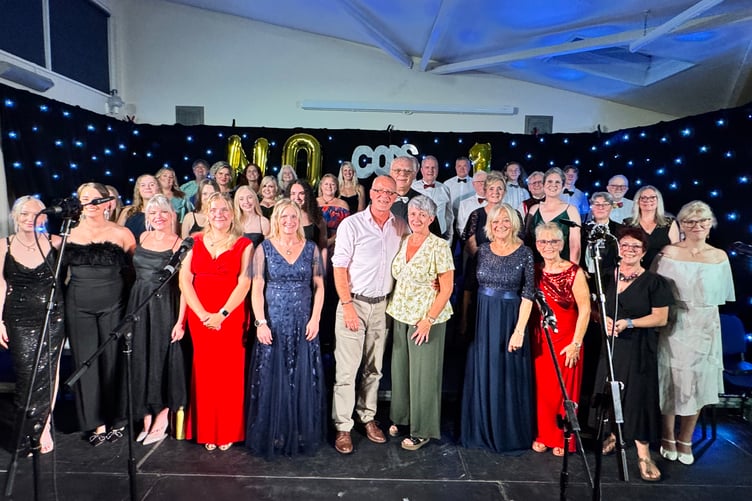 CODS singers with Musical Director Mike Canning and centre, Paul Steer of Devondale Electrical Distributors, concert sponsor. AQ 1355