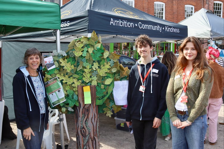 Town council Lead Youth Worker Cath Kelly, left, and Crediton Youth Service members Zeph and Imogen were collecting sustainability ideas for the town on their model tree