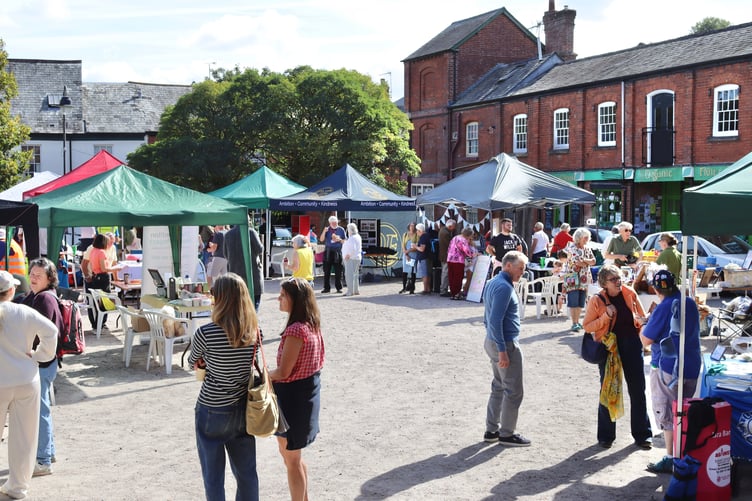 Various stalls and fair-goers in the Town Square