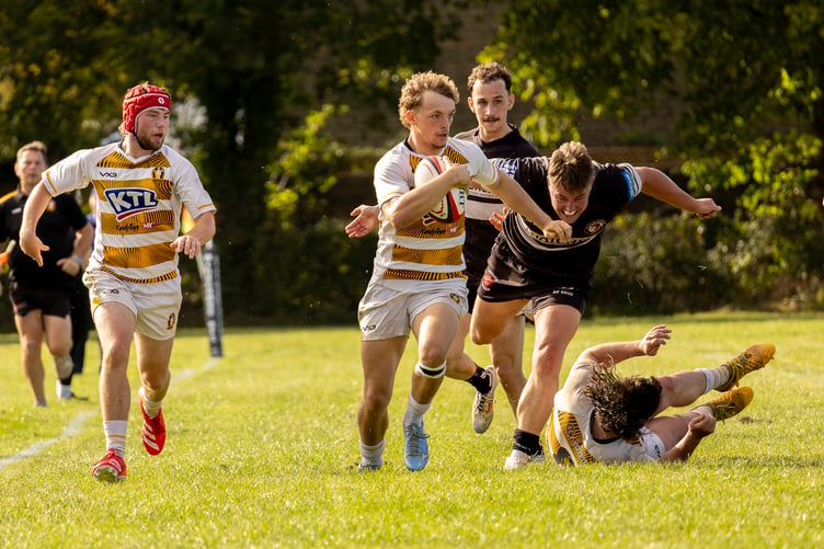 Charlie Cookson speeding past the Winscombe defence