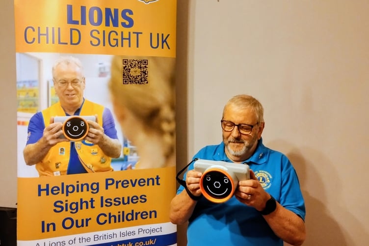 Lion Vision Screener John using the PlusoptiX infra-red camera to scan children’s eyes for undetected vision problems.