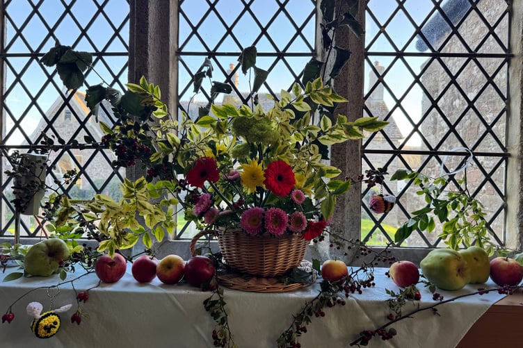 One of the harvest decorated windows in Coldridge Parish Church. AQ 1573