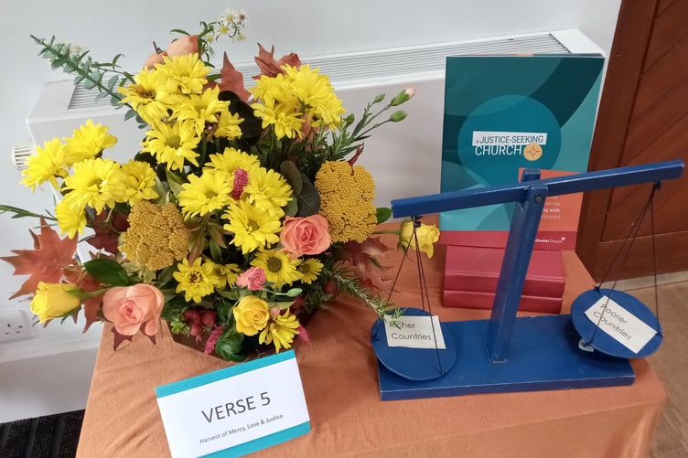 The floral arrangement with the theme Praise God for the harvest of mercy and love.