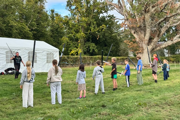 Children ready to learn about sword fighting. AQ 1889
