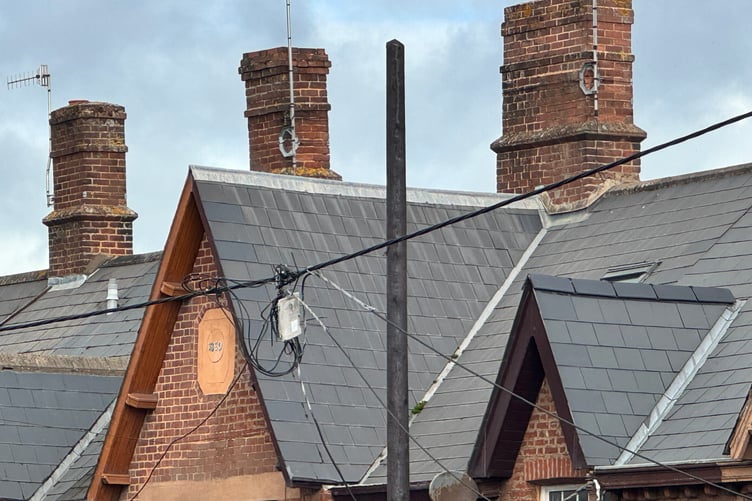 The wires hanging after the pole was demolished during a road accident in Charlotte Street, Crediton, the new pole now in place. AQ 3185