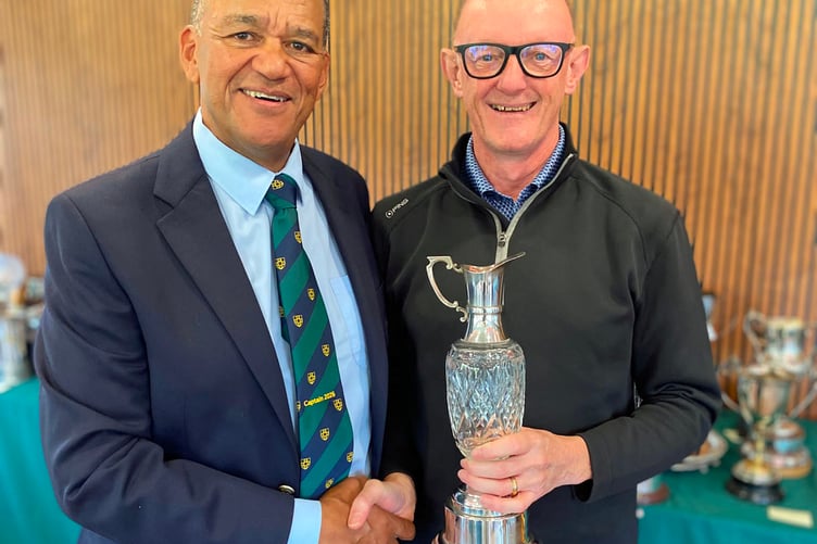 The Champions Trophy being presented to Steve Whyte by Captain Gerald Abdoll.