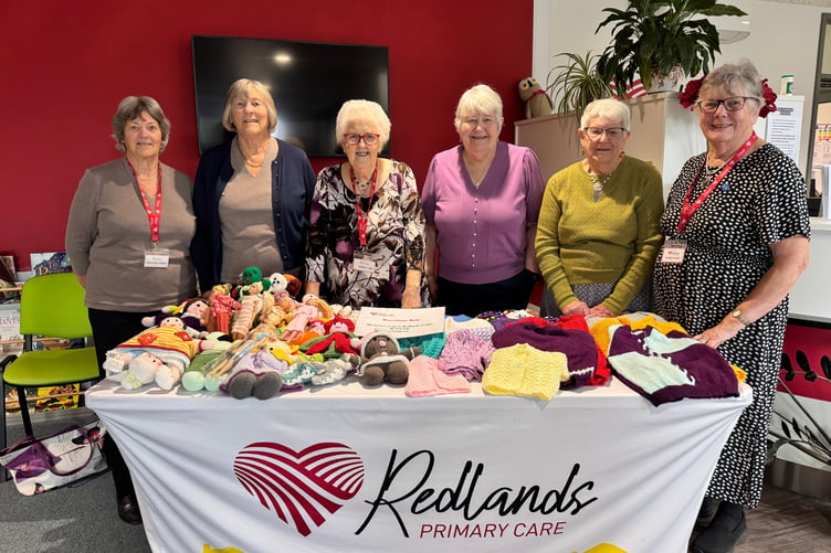Members of Redlands Primary Care League of Friends behind one of their stalls at the Open Day. AQ 3209