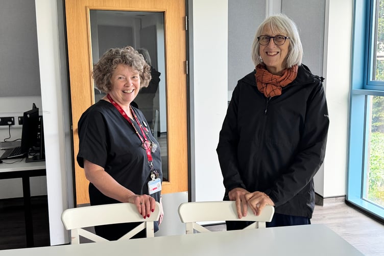 Sue Turner, Operations Manager, Redlands Primary Care, left, gives a visitor a tour of the practice. AQ 3221
