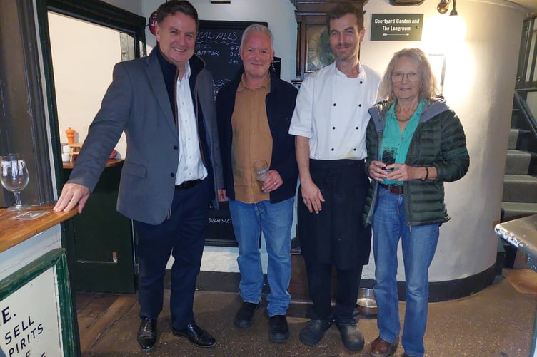 Sir Mel with volunteers at The Drewe Arms